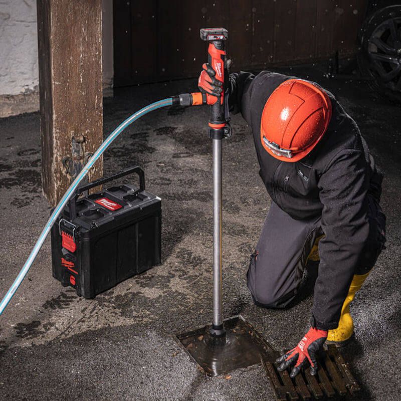 Action shot of the Milwaukee M12 HYDROPASS Brushed Stick Water Pump in use, efficiently pumping water from a debris-filled trench with HydroPass™ filter technology preventing clogs. Action shot of the Milwaukee M12 HYDROPASS Brushed Stick Water Pump in use, efficiently pumping water from a debris-filled trench with HydroPass™ filter technology preventing clogs.